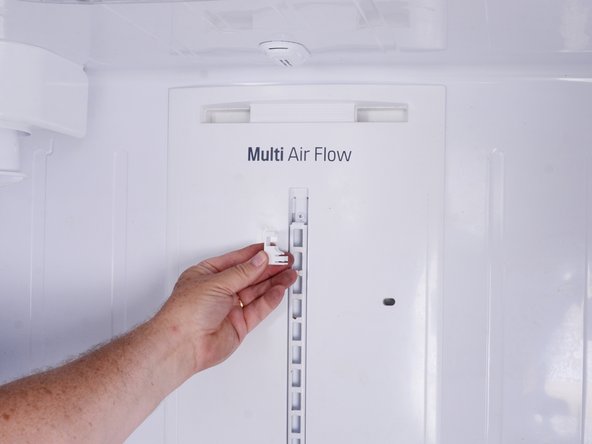How to Test and Replace the Rear Air Duct and Damper on your LG Refrigerator Model LFX25973, Remove the bracket screw covers: step 7, image 2 of 3