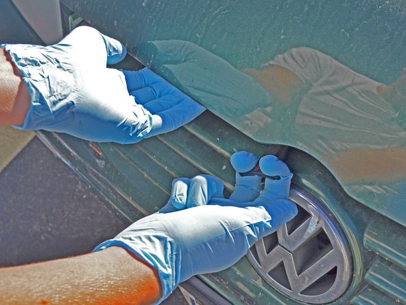 Use one hand to pull the lever straight forward while using the other to lift the hood.