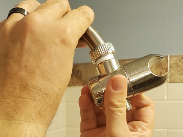How to replace the plumber's tape on a leaky shower head: step 3, image 1 of 2
