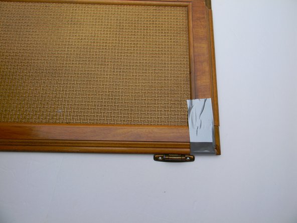 Flip door over to front side and tape both ends of the cabinet. This will add more support while it is drying.