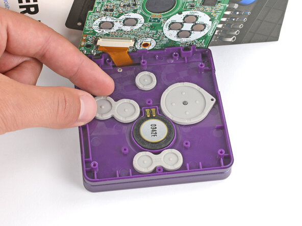 How to Reshell Your Game Boy Advance SP, Install the buttons and silicone pads: crwdns2935265:057crwdnd2935265:03crwdnd2935265:03crwdne2935265:0