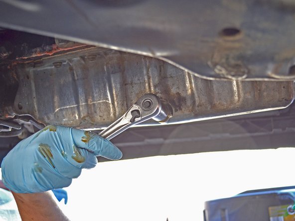 Finish tightening the oil drain plug using a socket wrench.