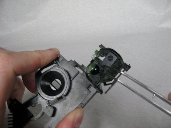 Lift the black piece out of the plastic plate.