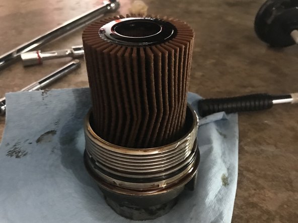 Remove the old oil filter from oil filter canister and replace with the new one.