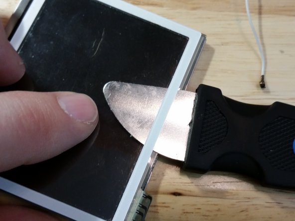 If you're replacing the shell with a different color, you definitely need to remove the sticker. With the iFixit metal spudger, this step is easy.