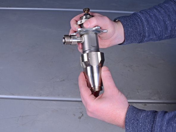 Unscrew and remove the intake valve from the pump cylinder.