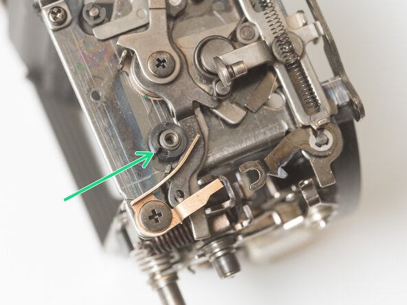 Pentax Super Program Mirror Box Mechanism Service, Remove mirror return latch: crwdns2935265:028crwdnd2935265:03crwdnd2935265:03crwdne2935265:0