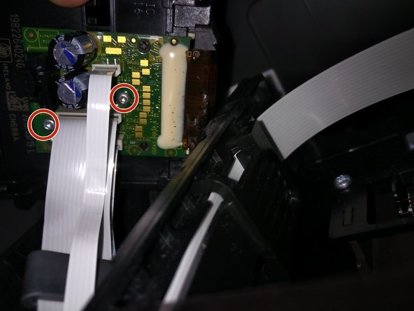 Prepare to remove the flat cables attached to the PCB. They are also connected to the print-head.