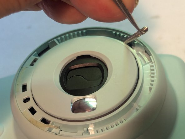 Fujifilm Instax Mini 9 Camera Shell Replacement, Disconnect the Brightness Adjustment Dial Return Spring: crwdns2935265:09crwdnd2935265:02crwdnd2935265:03crwdne2935265:0