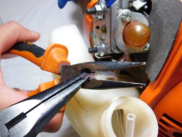Husqvarna Trimmer Gas Line Chamber Replacement, Fit lines into carburetor: step 12, image 2 of 3