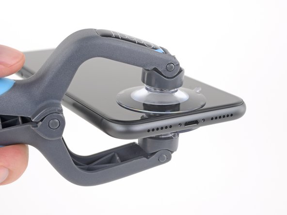 Hold onto your iPhone securely and close the handle of the iSclack to slightly separate the screen from the rear case of the phone.