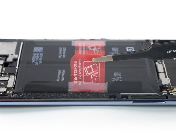 OnePlus Nord 2 5G Battery Replacement, Peel up the right pull tab: crwdns2935265:019crwdnd2935265:02crwdnd2935265:02crwdne2935265:0