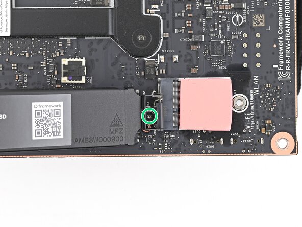 How to Install a Framework Desktop Mainboard Into a Mini‑ITX Case, Remove the secondary storage heat spreader screw: step 3, image 1 of 3