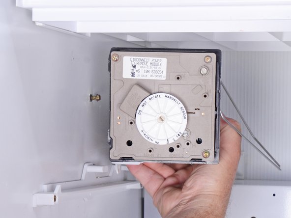 How to Replace the Ice Maker in an Older Whirlpool Refrigerator, Releasing the ice maker: step 9, image 3 of 3