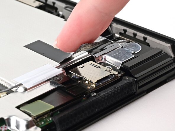 Nintendo Switch 2 MicroSD Card Reader Replacement, Press down the tape: crwdns2935265:031crwdnd2935265:01crwdnd2935265:02crwdne2935265:0
