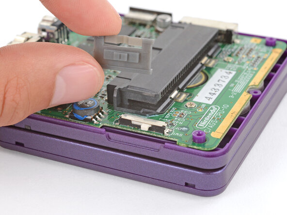 How to Reshell Your Game Boy Advance SP, Install the power switch cover: crwdns2935265:061crwdnd2935265:01crwdnd2935265:03crwdne2935265:0