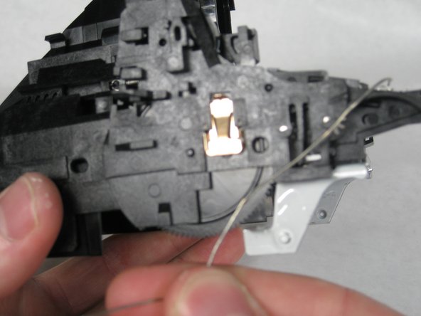 Remove the wire by sliding under the hooks.