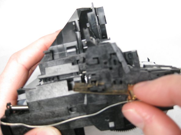 Remove the brass tab by lifting the top piece over the notch and sliding back.