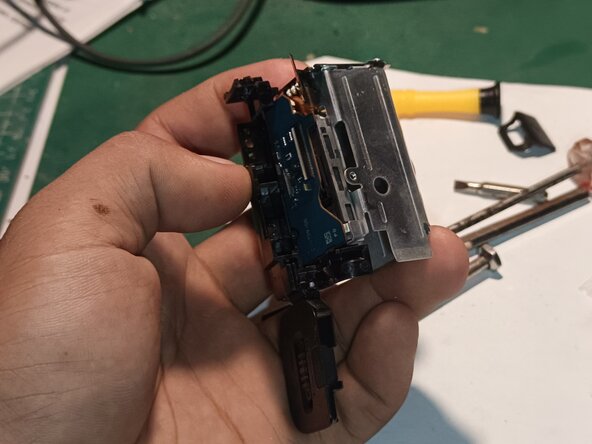 Teardown Sony ZV-E10 to reach SD card slot, Battery door and compartment removal: step 12, image 2 of 2