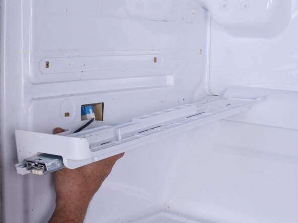 LG Refrigerator Evaporator Fan Replacement, Release lower left drawer slide and reposition it: crwdns2935265:010crwdnd2935265:03crwdnd2935265:03crwdne2935265:0