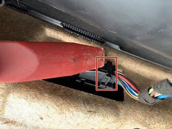 Rotate the lever from the wire side down towards the door panel.