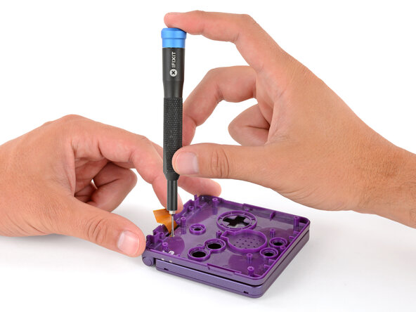 How to Reshell Your Game Boy Advance SP, Install the hinge cover screw: crwdns2935265:050crwdnd2935265:03crwdnd2935265:03crwdne2935265:0