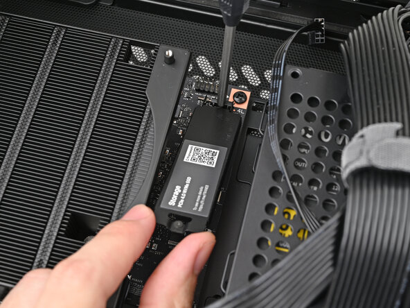 How to Install a Framework Desktop Mainboard Into a Mini‑ITX Case, Remove the primary storage heat spreader screw: step 13, image 1 of 3
