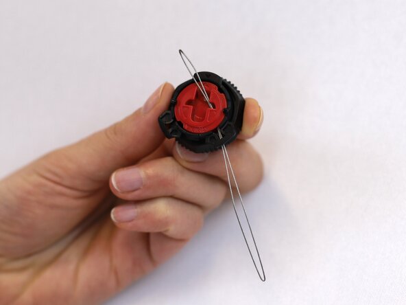 How to Replace a Dial-Lace System in a Hiking Boot, Insert the metal loop: crwdns2935265:012crwdnd2935265:03crwdnd2935265:03crwdne2935265:0