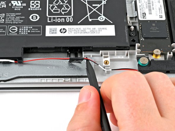 HP 15-fc0000 Series Speakers Replacement, Lift the speaker wire tape: crwdns2935265:08crwdnd2935265:02crwdnd2935265:02crwdne2935265:0