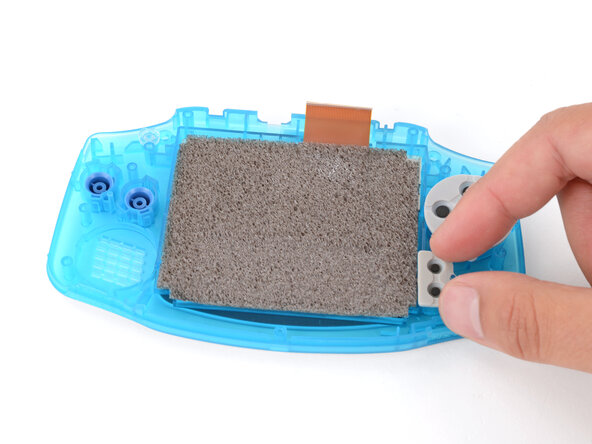 How to Reshell Your Game Boy Advance, Install the silicone pads: crwdns2935265:025crwdnd2935265:02crwdnd2935265:03crwdne2935265:0