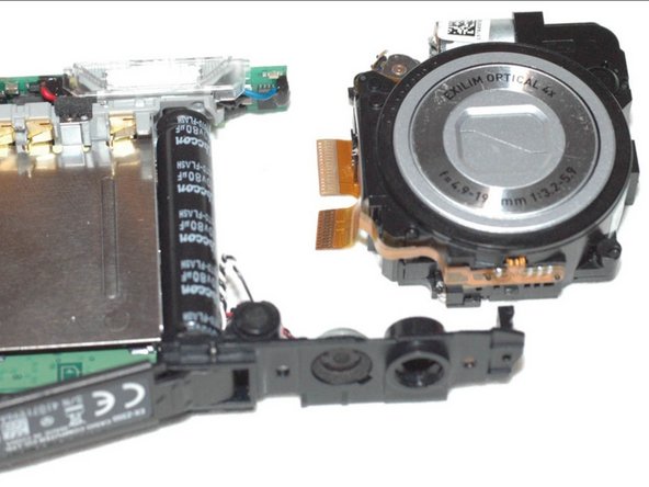 Repairing Casio Exilim EX-Z350 Lens mechanics, Remove lens body ribbon cable: crwdns2935265:010crwdnd2935265:03crwdnd2935265:03crwdne2935265:0