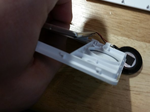 Begin pressing on the top screen as show here and work your way around. Be fairly gentle but note that the actual LCD is protected by a plastic shield in front and a metal shield in back.