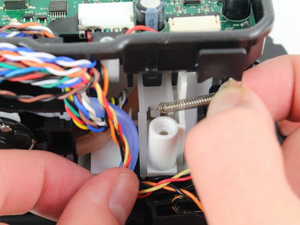 Remove the iRobot Braava Jet 240 Motherboard Case, Remove pad ejection lever spring: crwdns2935265:012crwdnd2935265:02crwdnd2935265:03crwdne2935265:0