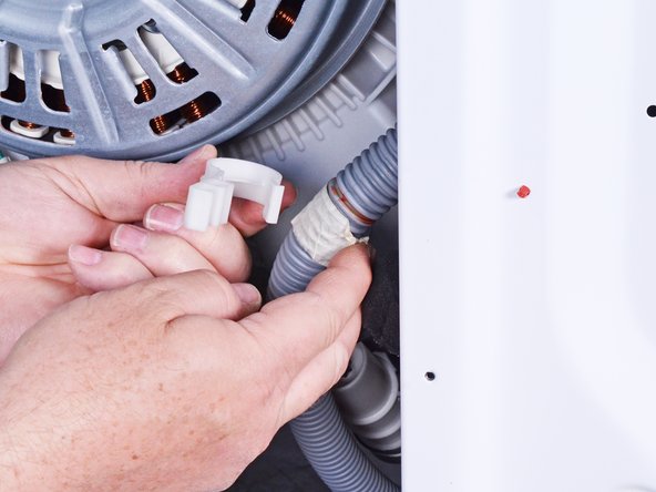 LG Front Load Washing Machine Drain Hose Replacement, Remove the plastic clip: crwdns2935265:036crwdnd2935265:03crwdnd2935265:03crwdne2935265:0