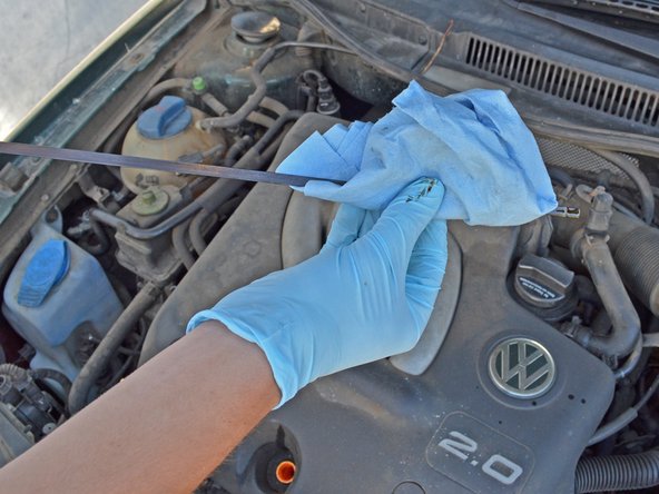 Wipe the dipstick down with a rag or towel to completely remove all oil so you can get a good read.