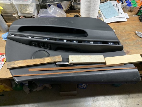 Using several clamps and pieces of wood (to distribute pressure), clamp the liner down to the door panel.