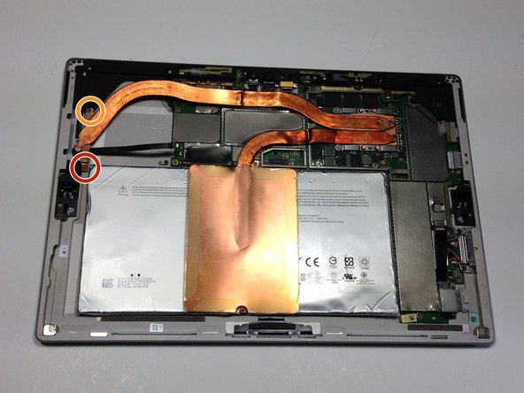 Remove the 1.5mm Torx T4 screw holding the heat sink tubing to the frame of the device.