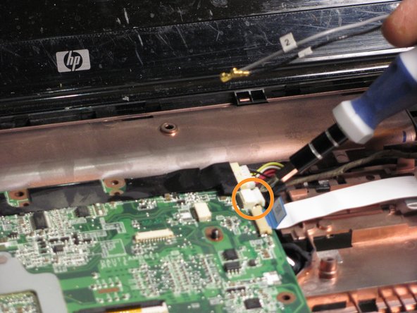 Disconnect the webcam/microphone cable from the system board.