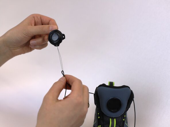 How to Replace a Dial-Lace System in a Hiking Boot, Insert the lace into the dial: crwdns2935265:013crwdnd2935265:02crwdnd2935265:03crwdne2935265:0