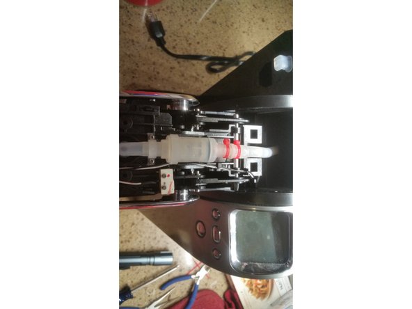 Blowing on the assembly may not work for some, so push on the back of the valve to break it loose.