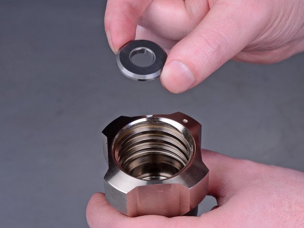 Use a pick tool to remove the ball seat washer from the bottom of the intake valve.