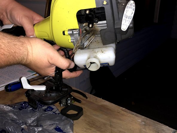 Lift and shake the edge trimmer until both lines fall out of the tank.