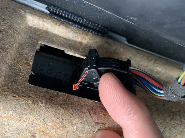 Rotate the lever from the wire side down towards the door panel.