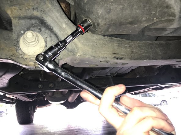 Using a ratchet and 14 mm socket, turn the drain plug counter-clockwise until drain plug comes out and oil starts to drain. Caution, oil may be warm if car had been operated within 30 minutes