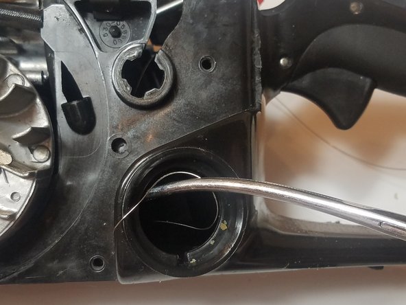 Use a pair of long needle nose pliers or hemostats to grab the other end through the gas tank