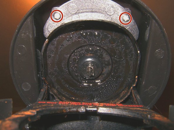 Next step is to remove the top cover to get to the water supply to the K-cup.  Open the Keurig. remove two Phillips screws that hold it in place.