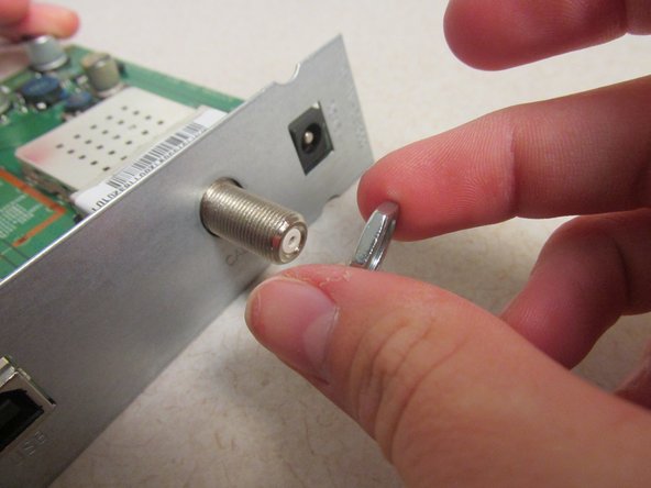 Motorola SURFboard SB5101 Face Plate Replacement, Unscrew the Silver Antennae Jack Screw: crwdns2935265:06crwdnd2935265:03crwdnd2935265:03crwdne2935265:0