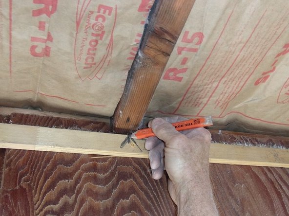 Mark an arrow on the wall (or trim piece, as shown)  and another arrow on the existing ceiling opposite, both pointing to the center of the middle ceiling rafter. Pic 2.