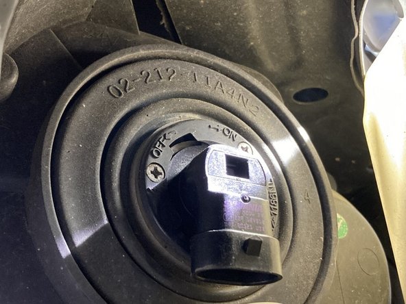 Grab the back of the bulb and rotate it counter-clockwise to the &quot;off&quot; position.