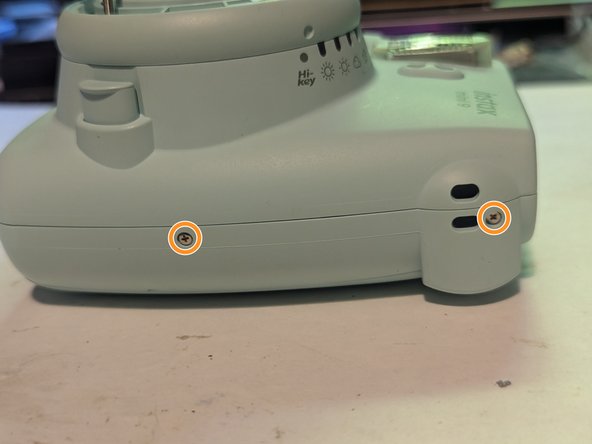 Fujifilm Instax Mini 9 Camera Shell Replacement, Remove the Shell Retaining Screws: crwdns2935265:011crwdnd2935265:02crwdnd2935265:02crwdne2935265:0